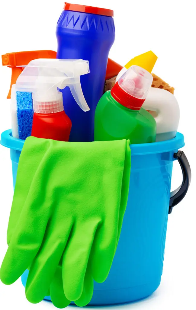 Liquid detergents and cleaning supplies in plastic bucket on white background