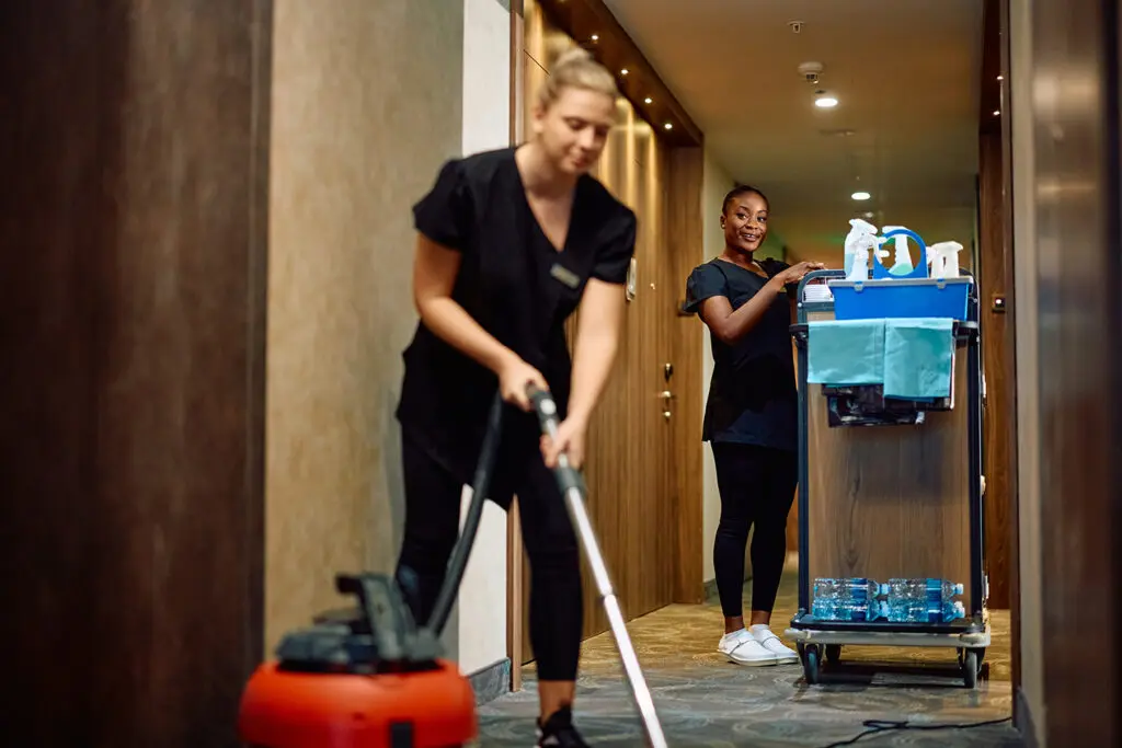 Technician cleaning carpet in commercial space